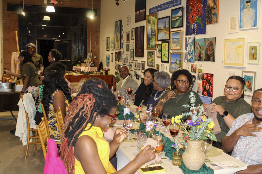a group of people at an art gallery dinner experience