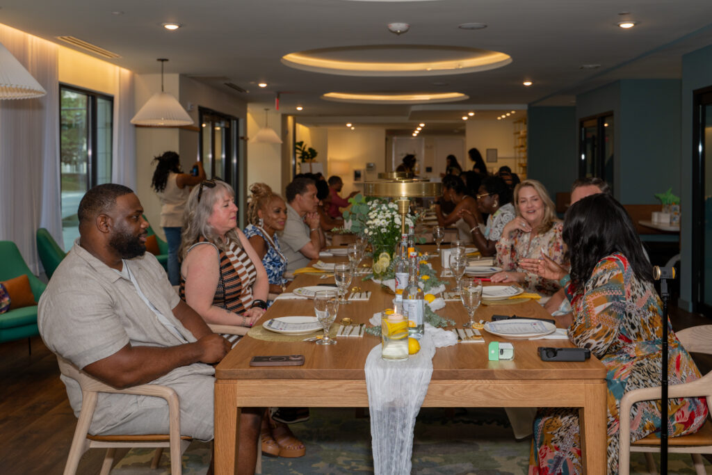 people seating at an luxury dinner at trella uptown apartments
